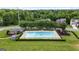 Community pool surrounded by manicured green spaces, with a cabana and lounge chairs at 736 Mesa Rd, Mcdonough, GA 30253