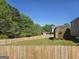 Well-maintained backyard features a large shed and a sturdy wooden fence for privacy at 1055 Field View Dr, Mcdonough, GA 30253