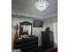 Primary bedroom with chic black dresser, stylish decor and a modern chandelier at 1055 Field View Dr, Mcdonough, GA 30253