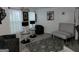 The living room boasts modern lighting, stylish decor and sleek, light flooring at 1055 Field View Dr, Mcdonough, GA 30253