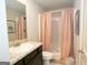 Neutral bathroom featuring a dark vanity and pink shower curtain at 223 Ferndale Dr # 114, Fairburn, GA 30213