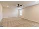 Large, carpeted bedroom with ceiling fan and a window with horizontal blinds at 223 Ferndale Dr # 114, Fairburn, GA 30213
