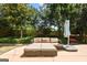 Backyard patio with comfortable seating and a shaded umbrella, ideal for relaxation at 340 Hammersmith Dr, Suwanee, GA 30024