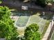Community basketball court surrounded by lush mature trees and green space at 340 Hammersmith Dr, Suwanee, GA 30024