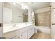 Bright bathroom with a double sink vanity and a shower-tub combo at 340 Hammersmith Dr, Suwanee, GA 30024
