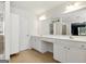 Bright bathroom featuring double vanity, tile flooring, and large mirror at 340 Hammersmith Dr, Suwanee, GA 30024