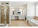 Bathroom with a glass door shower, double vanity, and separate bathtub at 340 Hammersmith Dr, Suwanee, GA 30024