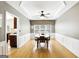 Formal dining room with hardwood floors and decorative crown molding is adjacent to kitchen at 340 Hammersmith Dr, Suwanee, GA 30024