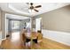 Well-lit dining room with hardwood floors, decorative trim, and a modern ceiling fan at 340 Hammersmith Dr, Suwanee, GA 30024