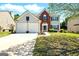 Two-story home with a well-manicured lawn, two-car garage, and combination brick and siding exterior at 340 Hammersmith Dr, Suwanee, GA 30024