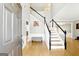 Welcoming two-story foyer features wood floors, elegant staircase with black railings, and neutral paint at 340 Hammersmith Dr, Suwanee, GA 30024