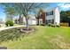 Inviting two-story home featuring a spacious front lawn, mature tree, and traditional architecture at 340 Hammersmith Dr, Suwanee, GA 30024
