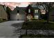 Inviting two-story home with a well-lit exterior, two-car garage, and a beautifully landscaped front yard at twilight at 340 Hammersmith Dr, Suwanee, GA 30024