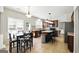 Well-lit eat-in kitchen features stainless steel appliances, an island, and a tile backsplash at 340 Hammersmith Dr, Suwanee, GA 30024