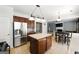 The kitchen features stainless steel refrigerator, center island and eat in table at 340 Hammersmith Dr, Suwanee, GA 30024