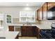 Well-lit kitchen with tile backsplash, stainless steel dishwasher, and modern appliances at 340 Hammersmith Dr, Suwanee, GA 30024