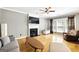 Sunlit living room showcases hardwood floors, fireplace, and comfortable seating at 340 Hammersmith Dr, Suwanee, GA 30024