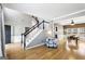 Open-concept living area with hardwood floors, high ceilings, and seamless transition to dining room at 340 Hammersmith Dr, Suwanee, GA 30024