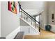 Welcoming staircase with black banister and wainscoting detail at 340 Hammersmith Dr, Suwanee, GA 30024