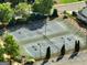 A well-maintained set of community tennis courts with new black fencing, lush green trees and lighting at 340 Hammersmith Dr, Suwanee, GA 30024