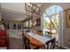 Dining room features an eye-catching modern chandelier and a picturesque view from a large arched window at 11 Line Creek Cir, Sharpsburg, GA 30277