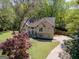 Well-maintained two-story home featuring a manicured lawn, mature trees, and a welcoming entrance at 11 Line Creek Cir, Sharpsburg, GA 30277