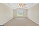 Open bedroom includes neutral carpet and paint, a ceiling fan, and a large window at 1313 Jubilee Ln, Mcdonough, GA 30253