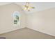 Neutral bedroom offers a ceiling fan and a large window for ample natural light at 1313 Jubilee Ln, Mcdonough, GA 30253