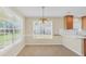 Bright dining area features a modern light fixture and large windows for ample natural light at 1313 Jubilee Ln, Mcdonough, GA 30253