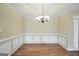 Bright and airy dining room with hardwood floors, chair rail molding and an elegant chandelier at 1313 Jubilee Ln, Mcdonough, GA 30253