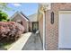 Charming brick home featuring an attached two-car garage, with a cozy entrance area and landscaped walkway at 1313 Jubilee Ln, Mcdonough, GA 30253