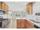 Beautiful kitchen with stainless steel appliances, white countertops, and light wood cabinetry, opening to dining area at 1313 Jubilee Ln, Mcdonough, GA 30253
