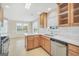 Updated kitchen with stainless steel appliances, white countertops, and light wood cabinetry, adjoining dining area at 1313 Jubilee Ln, Mcdonough, GA 30253