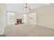 Inviting living room featuring a brick fireplace, neutral carpeting, and ample natural light at 1313 Jubilee Ln, Mcdonough, GA 30253