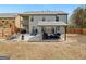 Spacious backyard featuring a covered patio with outdoor furniture and a well-maintained lawn at 3541 Stoneleigh Walk, Lithonia, GA 30038