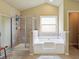 Bathroom featuring a tub and shower, and a window at 3541 Stoneleigh Walk, Lithonia, GA 30038
