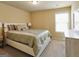 Bedroom featuring a neutral color scheme, natural light, and decorative throw pillows at 3541 Stoneleigh Walk, Lithonia, GA 30038