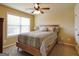 Bedroom with a window, ceiling fan, and bed with a striped comforter at 3541 Stoneleigh Walk, Lithonia, GA 30038