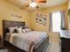 Bedroom featuring ceiling fan, natural light, decorative wall art and dark wooden furniture at 3541 Stoneleigh Walk, Lithonia, GA 30038