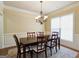 Bright dining room featuring a chandelier, a window, and a spacious table with seating at 3541 Stoneleigh Walk, Lithonia, GA 30038