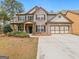 Charming two-story brick home with a well-manicured lawn and a spacious two-car garage at 3541 Stoneleigh Walk, Lithonia, GA 30038