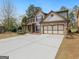 Beautiful two-story home with a large driveway and a well-maintained front yard at 3541 Stoneleigh Walk, Lithonia, GA 30038