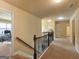 Upstairs hallway with a view of two bedrooms with carpet flooring, and the staircase at 3541 Stoneleigh Walk, Lithonia, GA 30038