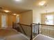 Upstairs hallway with a view of a bedroom with blinds and a decorative light fixture at 3541 Stoneleigh Walk, Lithonia, GA 30038