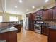 Modern kitchen featuring stainless steel appliances, dark cabinets, and granite countertops at 3541 Stoneleigh Walk, Lithonia, GA 30038