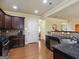 Well-equipped kitchen with dark wood cabinets, granite counters, and stainless steel appliances at 3541 Stoneleigh Walk, Lithonia, GA 30038