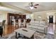 View of the kitchen island with barstool seating overlooking a comfortable living area with fireplace at 3541 Stoneleigh Walk, Lithonia, GA 30038