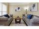 Comfortable living room featuring neutral tones, plush seating, and ample natural light at 3541 Stoneleigh Walk, Lithonia, GA 30038