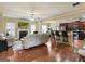 Spacious living room with barstool seating at kitchen island with hardwood flooring throughout at 3541 Stoneleigh Walk, Lithonia, GA 30038