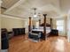 View of the main bedroom with hardwood flooring, a large bed and a cozy sitting area at 3541 Stoneleigh Walk, Lithonia, GA 30038